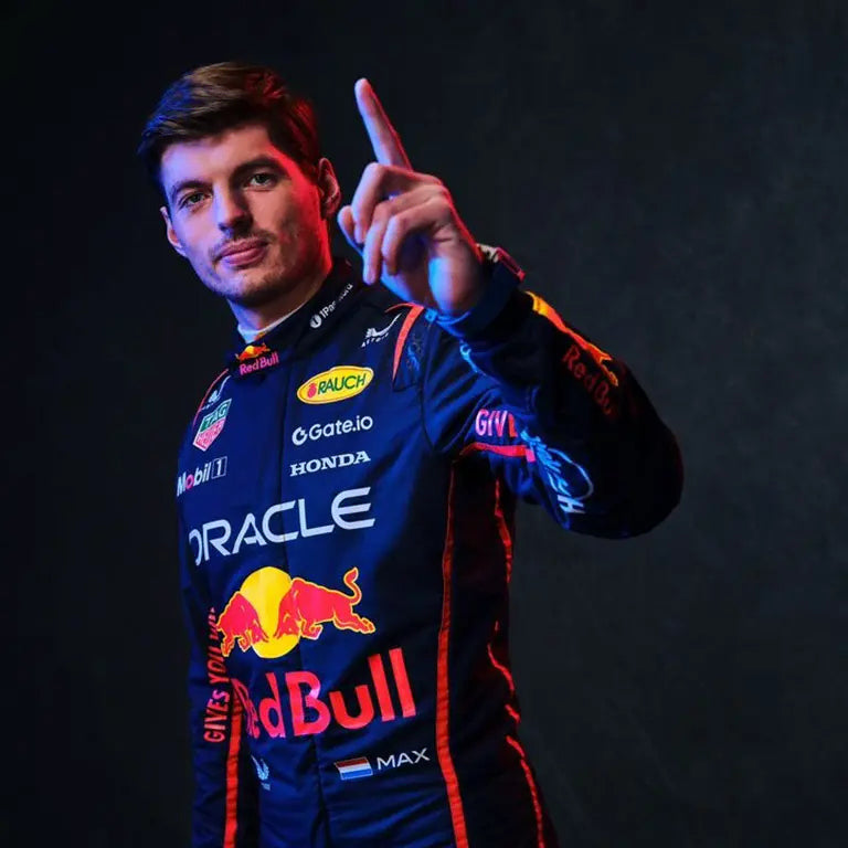 Full-body shot of Max Verstappen posing in his 2025 Red Bull Racing suit, with championship badges and a sleek blue-and-red design