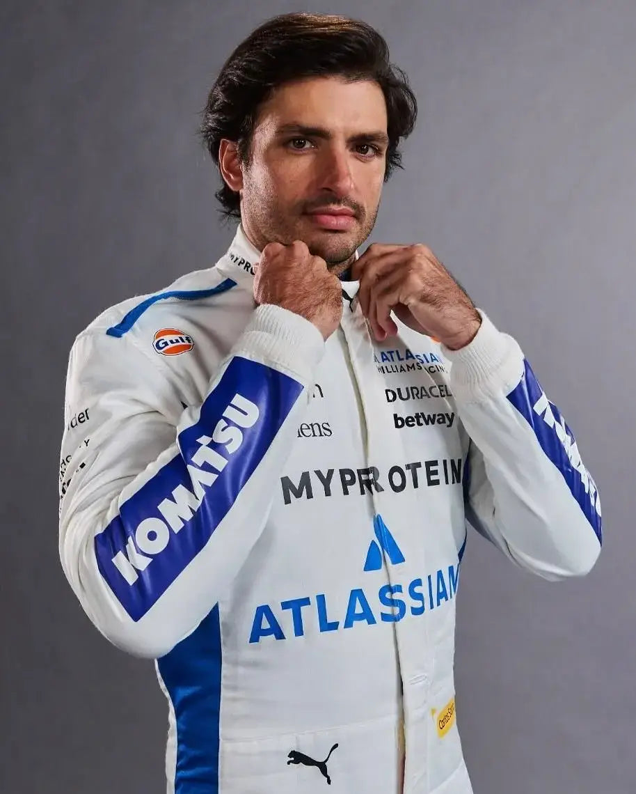 Carlos Sainz wearing the 2025 Williams F1 racing suit, standing confidently with car #55 branding visible