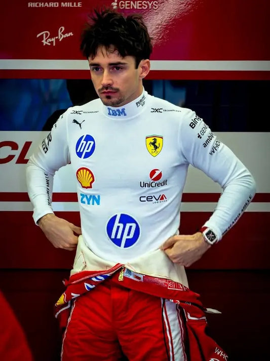 Person wearing a white racing suit with various sponsor logos in front of a red background.