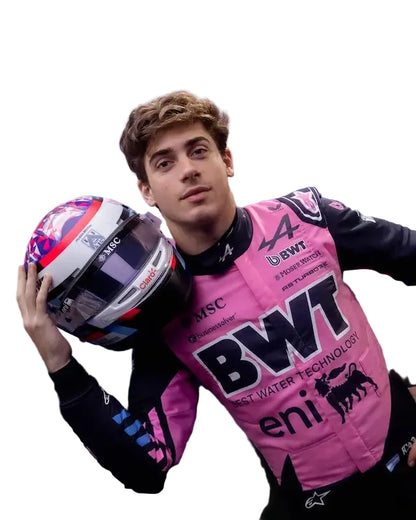 Franco Colapinto bwt f1  pink racing suit with BWT and Eni logos, holding a helmet.
