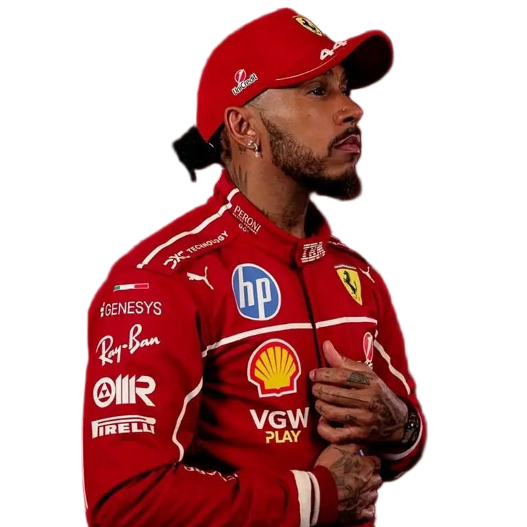 Lewis Hamilton in a sharp, tailored black suit with a white dress shirt and no tie, posing on the red carpet