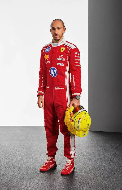 Person wearing a red racing suit with various sponsor logos, holding a yellow helmet.
