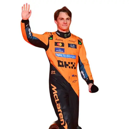 Full-body image of Oscar Piastri modeling the official 2025 McLaren F1 replica suit in papaya orange and stealth black