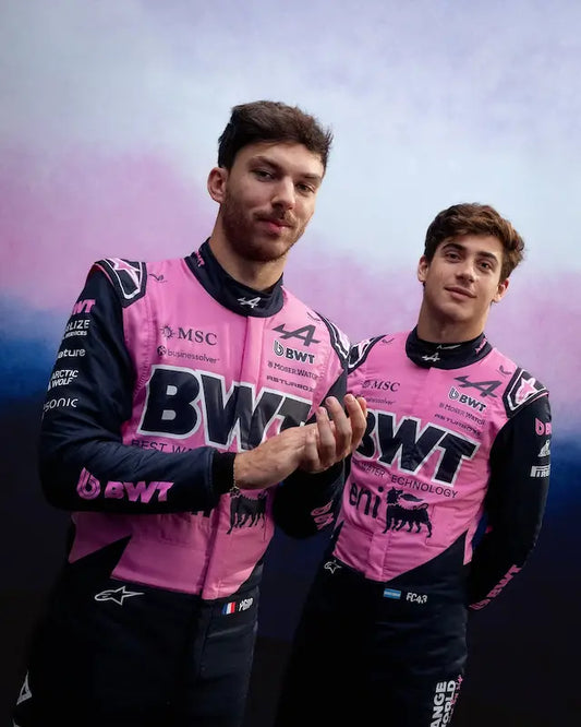 Both Alpine F1 replica suits displayed, showcasing the team's blue and pink colors.