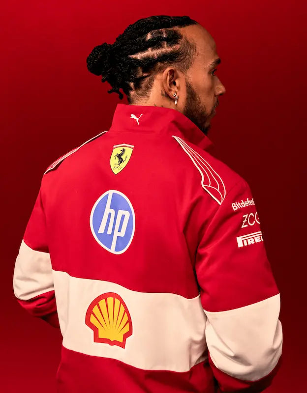 Person wearing the official Puma for Scuderia Ferrari HP 2025 red softshell team jacket at a racetrack