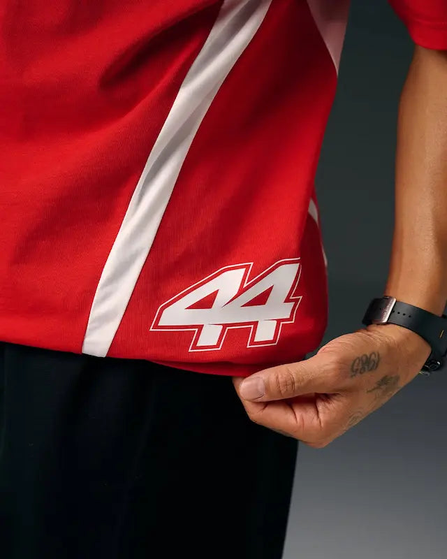 Close-up detail of the #44 and Hamilton name printed on Ferrari red fabric.